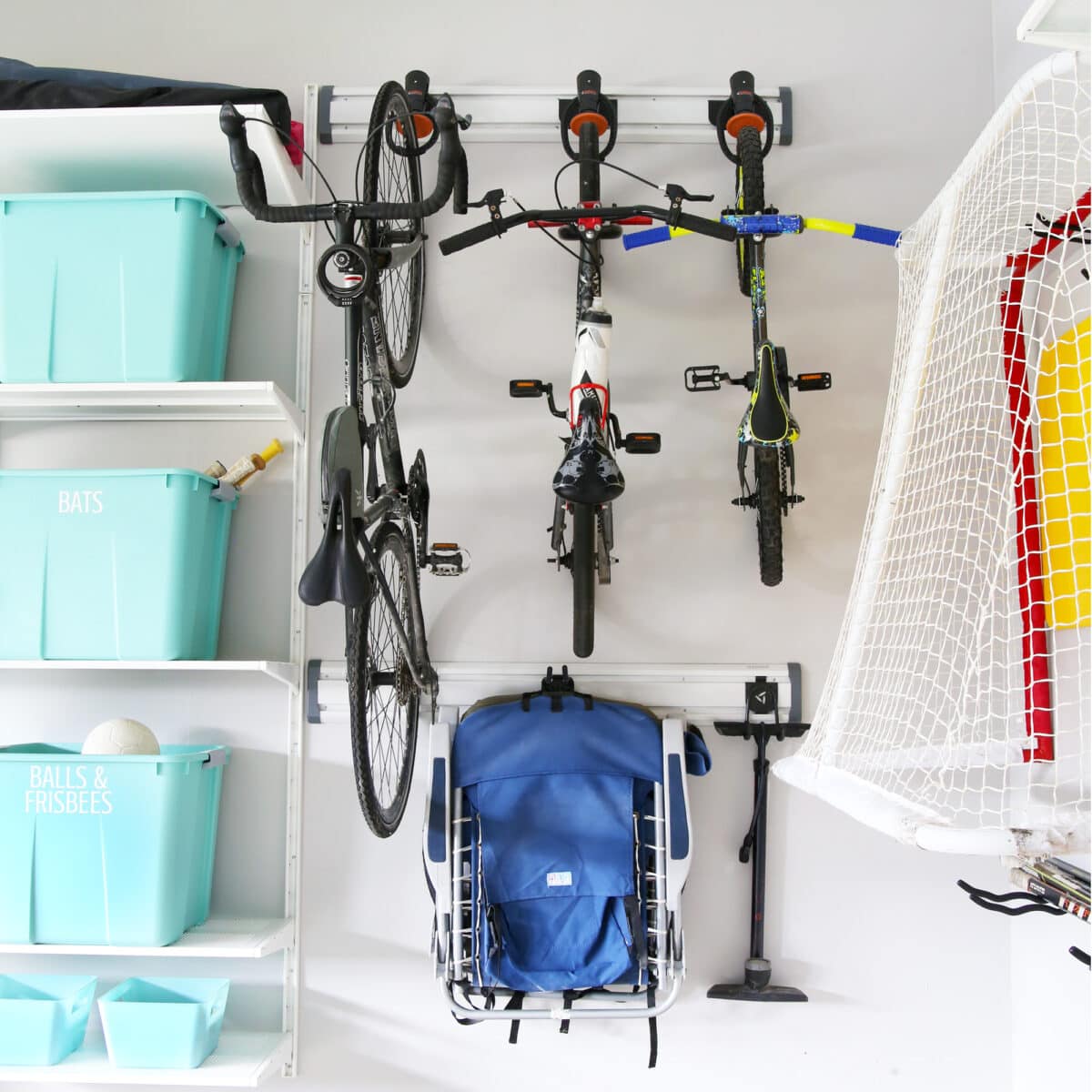 Bikes stored on a wall track system in an organized garage